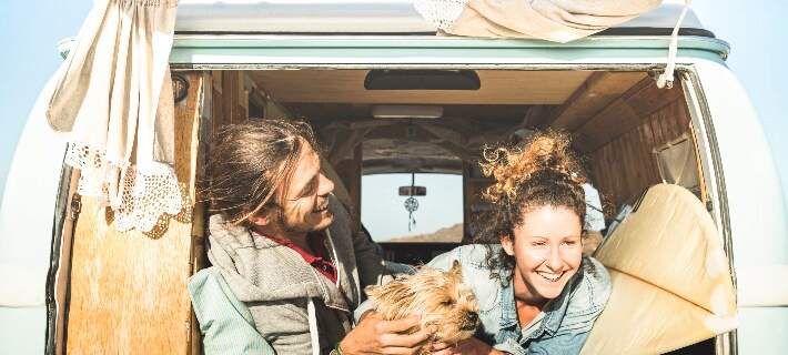 Couple and dog in back of camping van